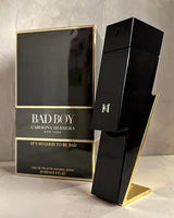 Carolina Herrera Bad Boy men's perfume bottle with sleek black and silver design, displayed on a neutral background.