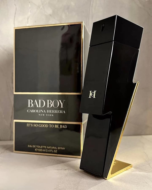 Carolina Herrera Bad Boy men's perfume bottle with sleek black and silver design, displayed on a neutral background.