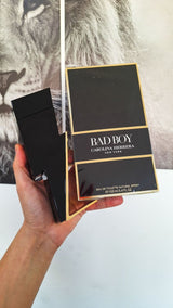 Carolina Herrera Bad Boy men's perfume bottle with sleek black design, featuring bold branding and modern aesthetic.
